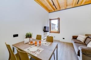a living room with a table and a couch at Casa Contrada in Gargnano