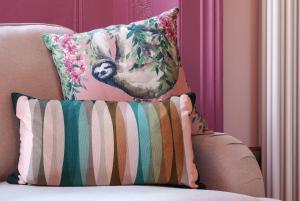 a couch with a pillow with a monkey on it at The Rose Nobel - 1 Bed Studio Apartment in Bristol by Mint Stays in Bristol