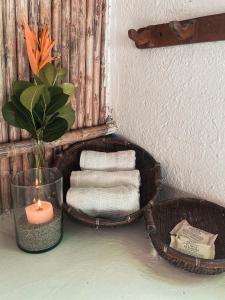 a basket with towels and a candle on a table at Reserva Natural El Matuy in Palomino