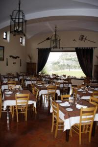a restaurant with tables and chairs and a large window at Villa Turística de Grazalema in Grazalema