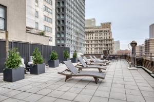 a row of benches on a balcony in a city at FiDi 1br w gym doorman elevator nr Wall St NYC-1051 in New York