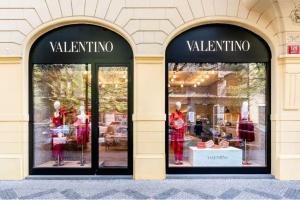 two windows of a valentino store with mannequins at Prague Elite Residences - Parizska street apartment 150 m2 in Prague