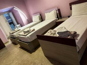 a room with two beds and a window at Sina Rent Room in Rome