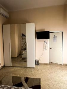 a white cabinet with a mirror in a room at Sina Rent Room in Rome +155 photos