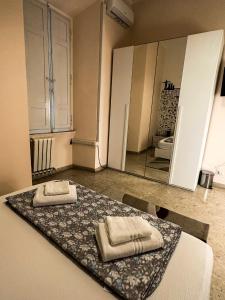 a room with two towels on a bed with a mirror at Sina Rent Room in Rome