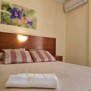a bedroom with a large bed with a flower painting on the wall at Marazul By Fitzgeralds in Nerja