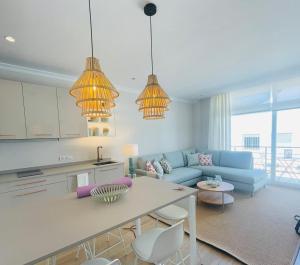 a kitchen and living room with a couch and a table at Zahara Pueblo villas y apartamentos in Zahara de los Atunes