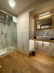 a bathroom with a glass shower and a sink at signoria flat 5* centro storico in Florence +8 photos