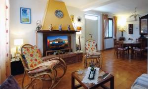 a living room with a fireplace and a dining room at I Pini House in Magione