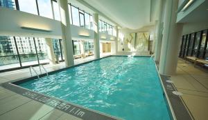 a large indoor swimming pool in a building at Spacious Lakefront Condo+Parking+Pool+Gym+Patio in Toronto