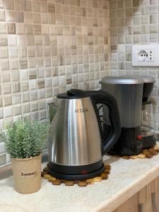 a coffee pot sitting on top of a counter at Ridi's Comfort Apartment in Shkodër