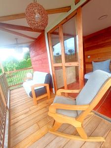 a room with a balcony with a bed and chairs at Hotel Rancho El Vergel in Montenegro