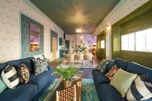a living room with a blue couch and a table at The Royal Mint - 2 Bedroom Apartment in Central Bristol by Mint Stays in Bristol