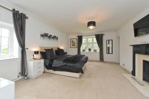 a bedroom with a bed and a fireplace at Amazing 100 year old church Rectory in Brentwood