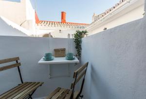 a small table and two chairs on a patio at San Miguel Tranquilo Moderno in Jerez de la Frontera