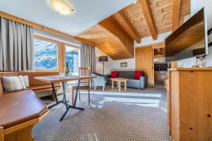 a living room with a couch and a table at Schönblick - Gurgl B&B in Obergurgl