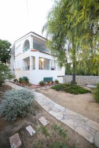 a white house with a tree in front of it at AKAKIA VILLA NAFPLIO in Nafplio +19 photos