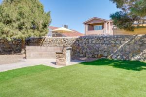 a stone retaining wall with a bench in a yard at Pet-Friendly El Paso Retreat 20 Mi to Downtown! in El Paso