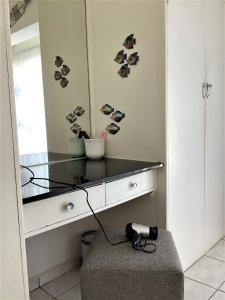 a room with a counter with a mirror and a camera at Nomads Nook 15 in Ramsgate