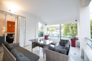 a living room with a table and chairs at AKAKIA VILLA NAFPLIO in Nafplio