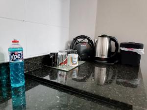 a bottle of water sitting on top of a kitchen counter at Apezinho 209 in São Leopoldo