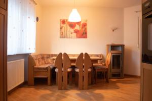 a dining room with a table and chairs at Strategic apartment - near Bolzano in Prato allʼIsarco