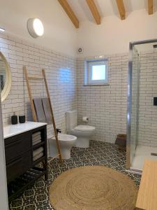 a bathroom with a toilet and a sink and a shower at Monte da Rocha in Santiago do Cacém