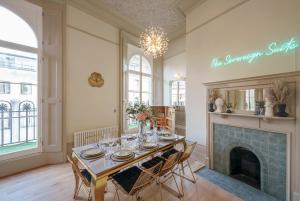 a dining room with a table and a fireplace at The Sovereign Suite - 2 Bedroom Apartment in Central Bristol by Mint Stays in Bristol