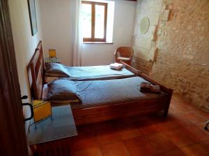 two twin beds in a room with a window at La Chillaudie in Verteillac