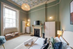 a living room with a couch and a fireplace at The Sovereign Suite - 2 Bedroom Apartment in Central Bristol by Mint Stays in Bristol