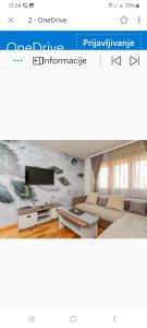 a website of a living room with a couch and a tv at Apartments Gorska in Kolašin