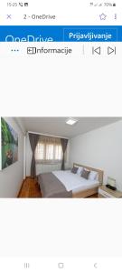a website of a bedroom with a bed in a room at Apartments Gorska in Kolašin