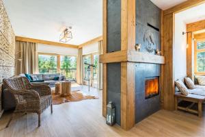 a living room with a fireplace in a house at Rent like home - Willa Zoniówka PREMIUM in Zakopane