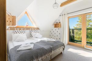 a bedroom with a bed and a large window at Rent like home - Willa Zoniówka PREMIUM in Zakopane