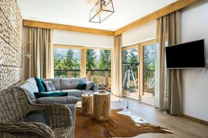 a living room with a couch and a tv at Rent like home - Willa Zoniówka PREMIUM in Zakopane +36 photos