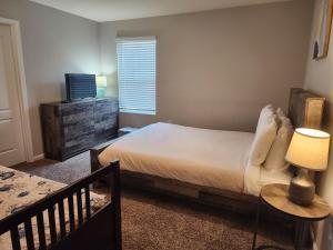 a bedroom with a bed and a dresser and a window at Get Close to the Action! in Jacksonville