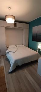 sypialnia z dużym białym łóżkiem w pokoju w obiekcie L'alloggetto sul Corso w mieście Cuneo