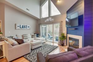 a living room with a couch and a fireplace at Camdenton Condo with Patio, Pool and Lake Access! in Camdenton