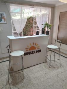 two chairs and a counter with a house turn sign at Houselyon in Mendoza