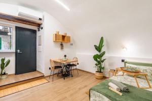 a room with a bed and a table and a desk at Varriale house ecogreen in Naples