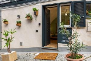 a door to a cafe with plants in front of it at Varriale house ecogreen in Naples