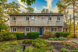 a brick house with bushes in a yard at Mill Pond Vista in Chatham