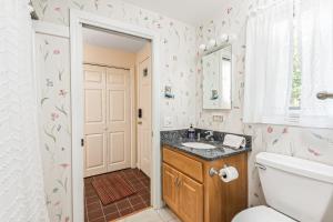 a bathroom with a toilet and a sink at Mill Pond Vista in Chatham