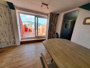 a dining room with a table and a large window at Murmullos Do Mar in A Coruña