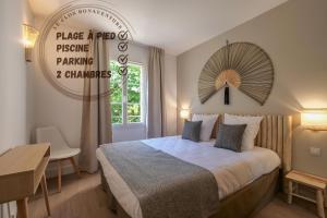 a hotel room with a bed and a sign on the wall at Dolce Vita Plage et St Tropez - 10 in Saint-Tropez +19 photos
