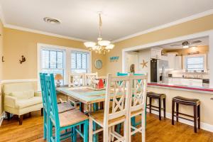 a kitchen and dining room with a table and chairs at Nautical Niche-Master in Galveston