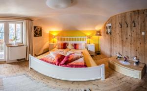 a large bedroom with a large bed with pillows at Haus Guglprasta in Sankt Veit in Defereggen