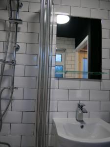 a bathroom with a sink and a mirror at Queens Cottage, Wivenhoe Stylish, Plush, Cosy, Convenient & Quirky, 2x Double Bed Period Cottage PLUS Patio - 9 min walk train, 4 min walk High Street Pubs, Restaurants, Shops in Wivenhoe