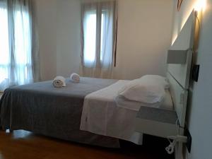 a bedroom with a bed with two towels on it at Ca' Piave in Mestre