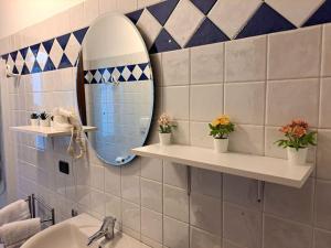 a bathroom with a mirror and a sink at Ca' Piave in Mestre